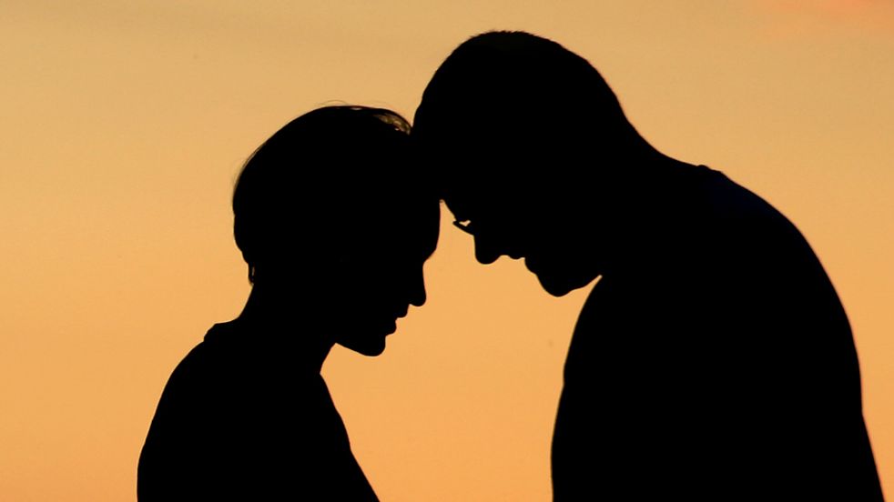 Generic silhoutte of a man and a woman with their foreheads touching