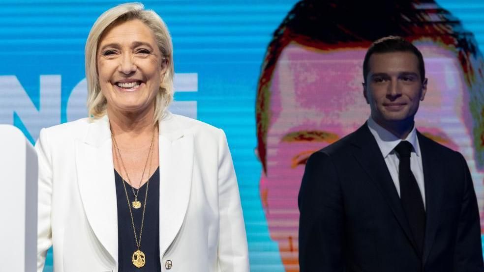 National Rally parliamentary party leader Marine Le Pen (L), standing next to leader Jordan Bardella (R)