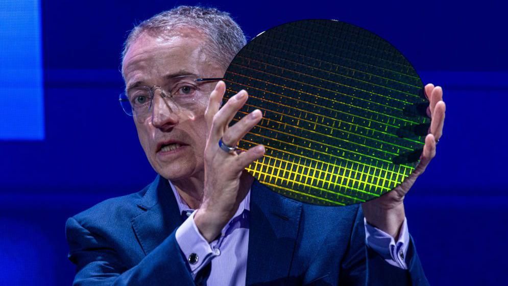 Pat Gelsinger, Intel chief executive, holds a chip wafer as he speaks at a conference