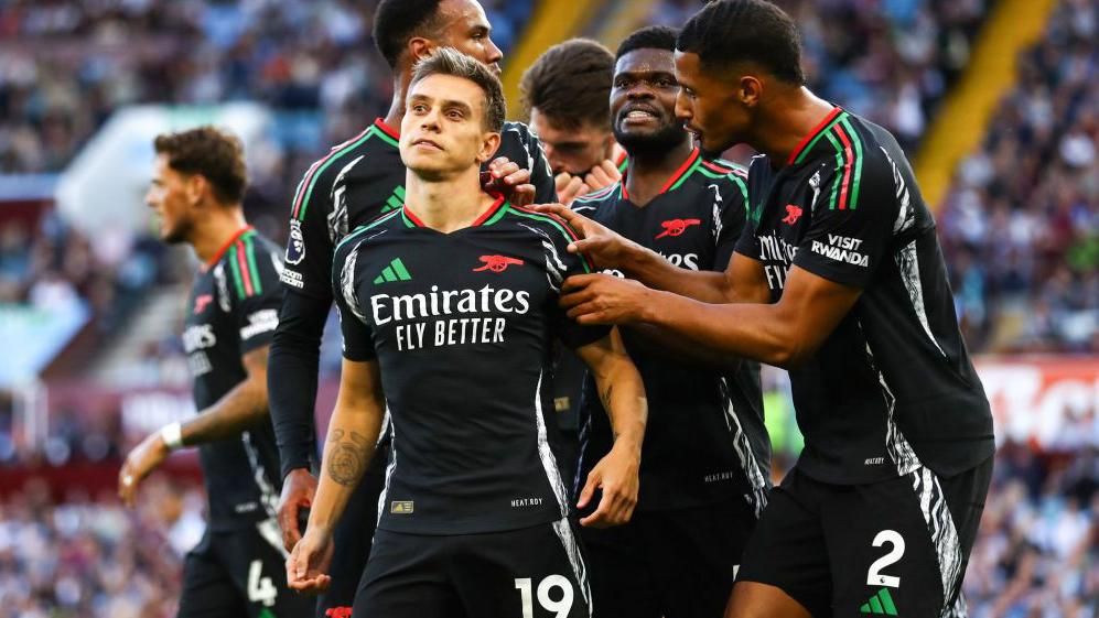 Arsenal players celebrate scoring at Aston Villa in August