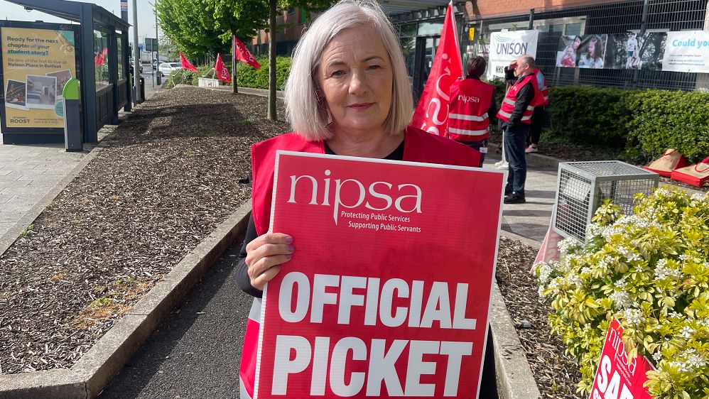 NIPSA's President Tanya Killen holding a picket sign