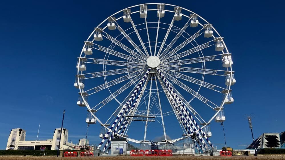 Complete wheel with seafront in background
