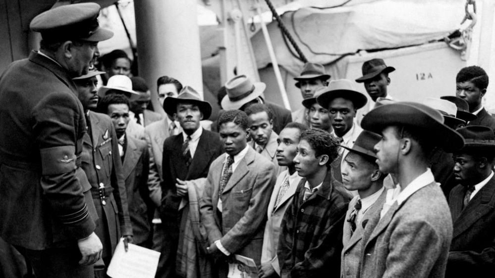  Jamaican immigrants welcomed by RAF officials from the Colonial Office after the ex-troopship HMT Empire Windrush landed them at Tilbury