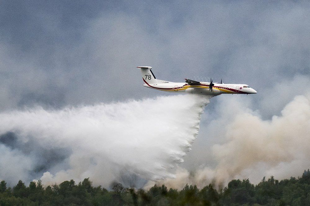 A De Havilland Canada Dash 8-400 MR aircraft drops water