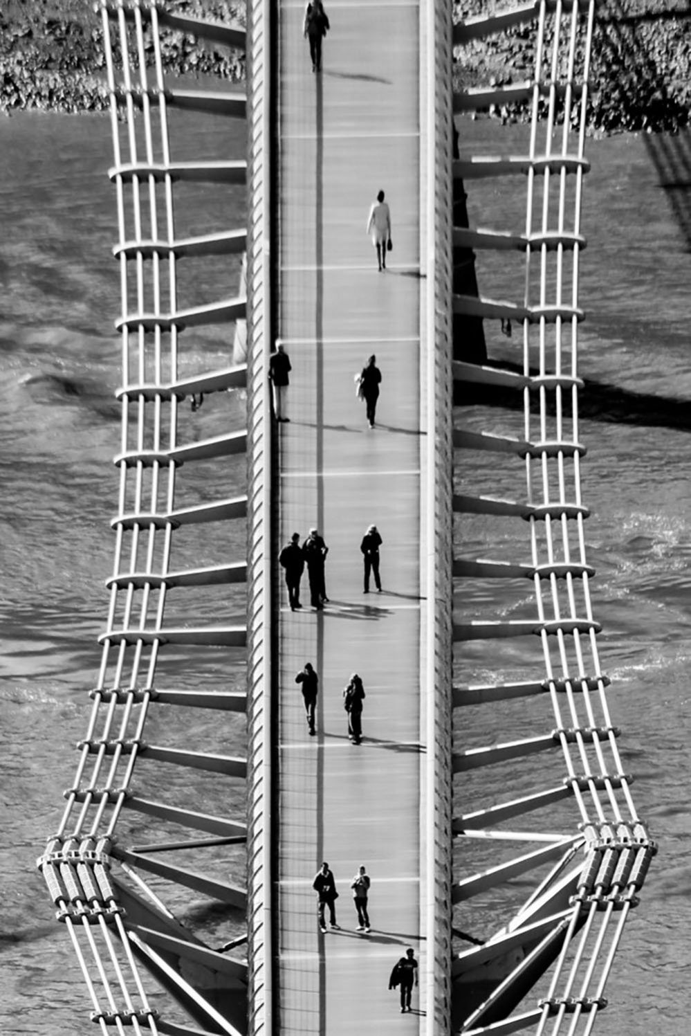 People walking across the Millennium Bridge