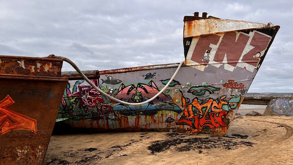 Ship covered in graffiti