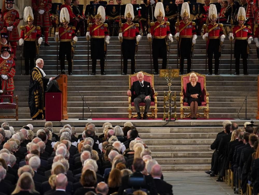 King Charles III and the Queen Consort listen to Speaker of the House of Lords Lord McFall of Alcluith