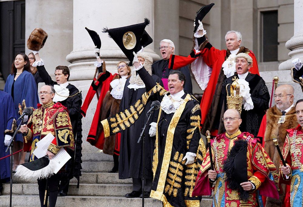 Officials and elected members of the City of London Corporation doff their hats