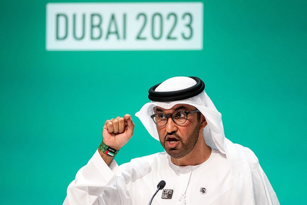 Dr. Sultan Ahmed Al Jaber, President-Designate of COP28 and UAE's Minister for Industry and Advanced Technology, gestures at a press conference, with 'Dubai 2023' written on the screen behind