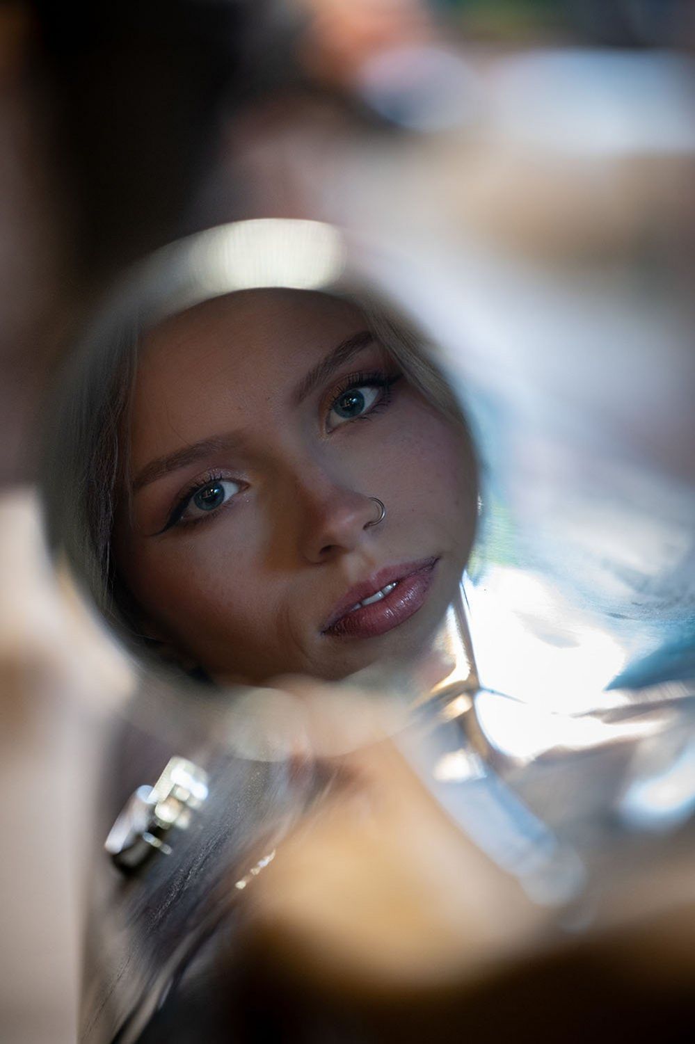 A woman's face in a car mirror
