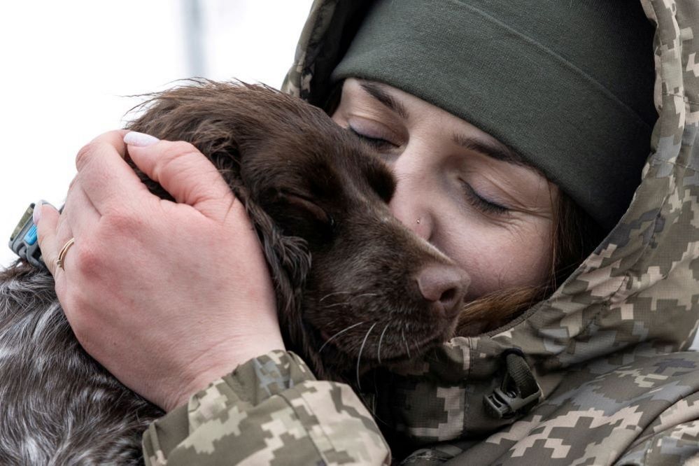 Alina Panina hugs her service dog Roksi