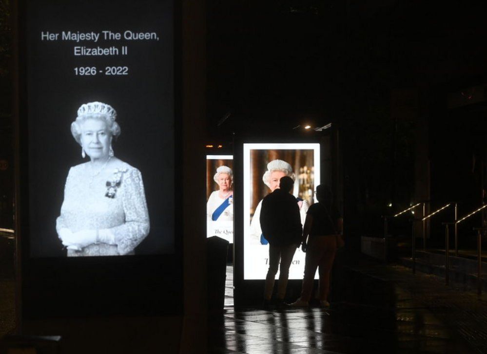 Digital advertising boards at bus stops displayed pictures of the Queen