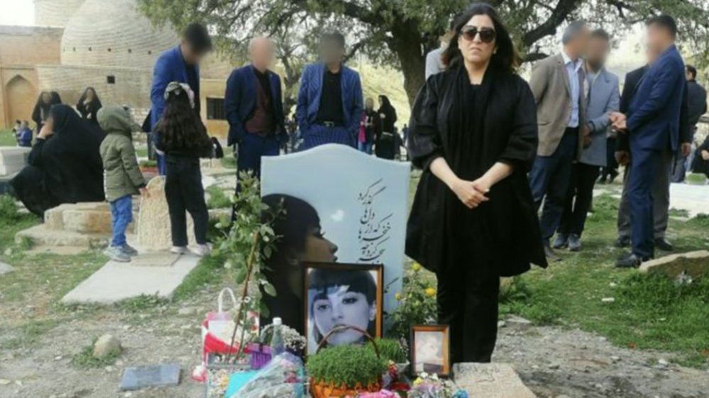 Nasrin Shakarami stands beside the grave of her daughter, Nika Shakarami