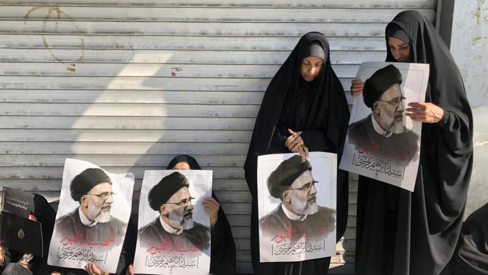 Iranians hold portraits of late president Ebrahim Raisi as they mourn during a funeral processions ceremony in Tehran, Iran, 22 May 2024.