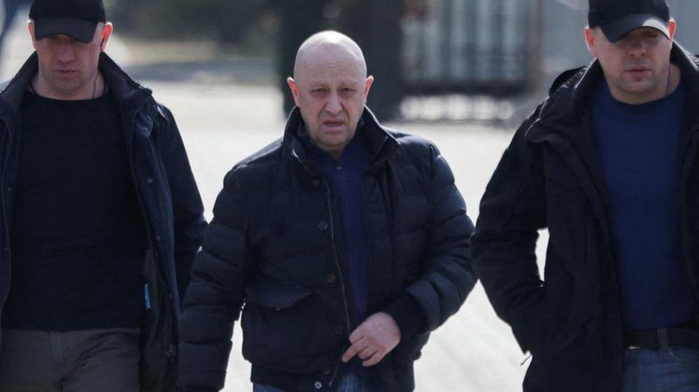FILE PHOTO: Founder of Wagner private mercenary group Yevgeny Prigozhin walking along with two protection officers