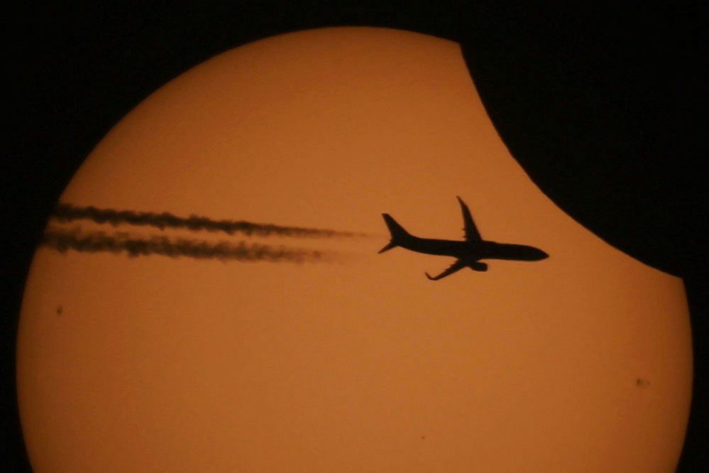 An aircraft in front of the sun