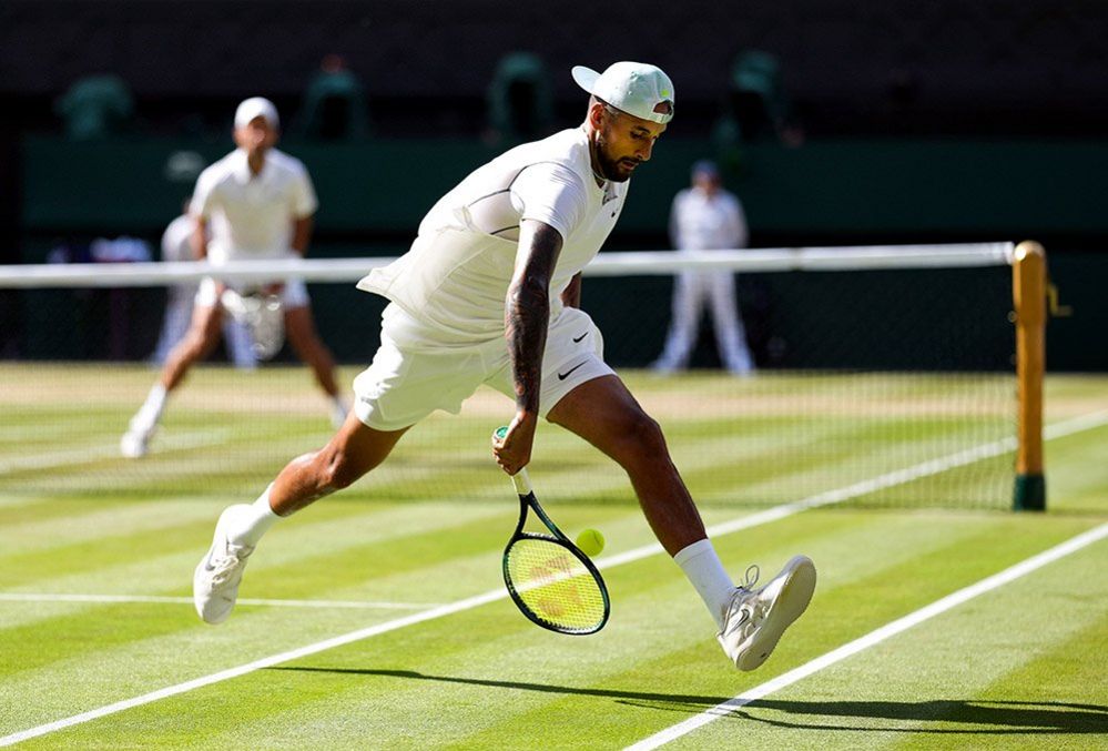 Nick Kyrgios plays a shot through his legs during the final of the Gentlemen's Singles against Novak Djokovic on day fourteen of the 2022 Wimbledon Championships, 10 July 2022