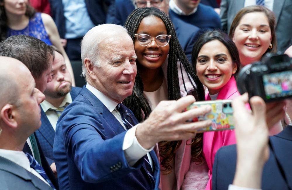 US President Joe Biden takes a selfie with students at Ulster University, Belfast, Northern Ireland, 12 April 2023
