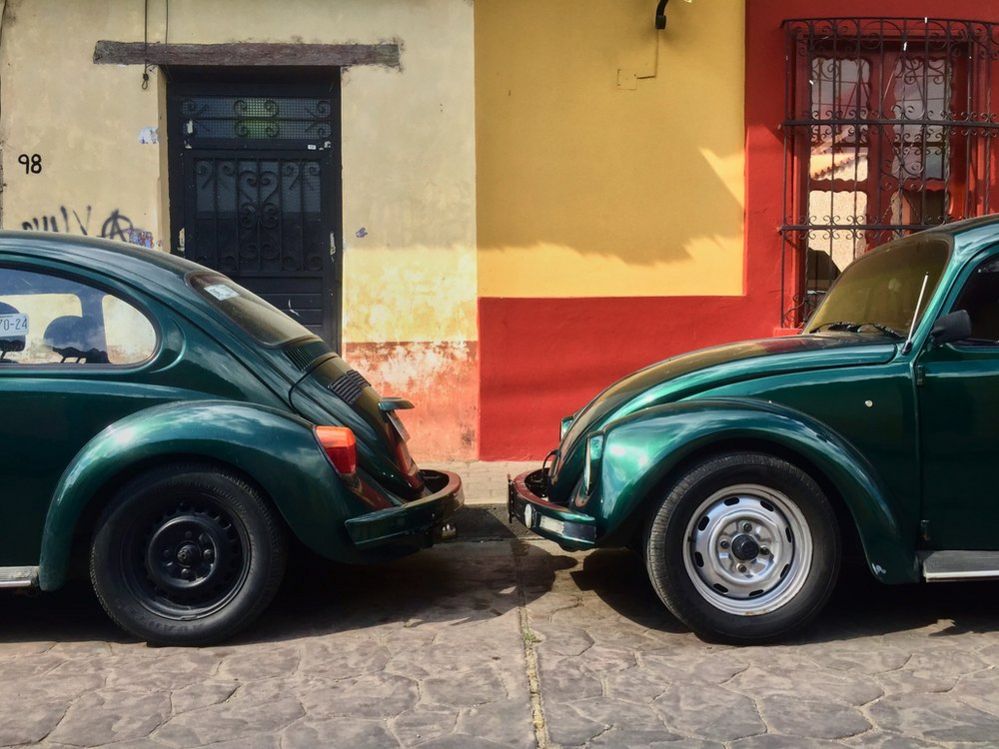 Two Volkswagen Beetles parked next to each other