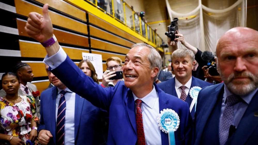 Nigel Farage gives a thumbs up after winning the Clacton seat
