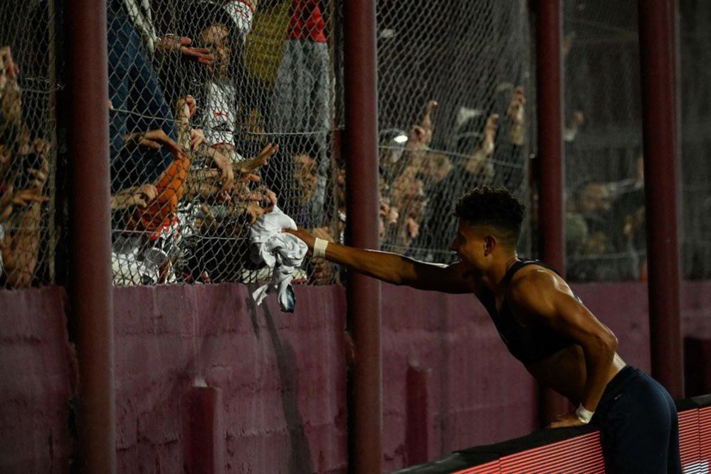 Liga de Quito's defender Daykol Romero gives his jersey to the fans in Banfield, Buenos Aires