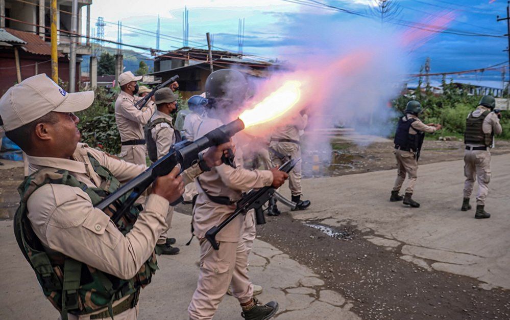 A policeman fires tear gas to the protesters as they demand restoration of peace in India's north-eastern state of Manipur after ethnic violence, in Imphal on September 21, 2023