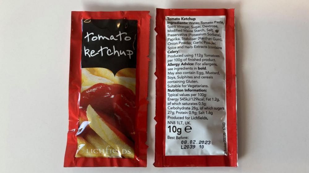 Two sachets of tomato ketchup