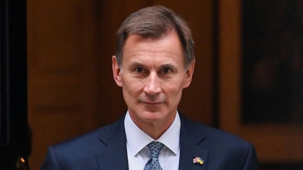 Chancellor Jeremy Hunt seen walking out the front door of 11 Downing Street