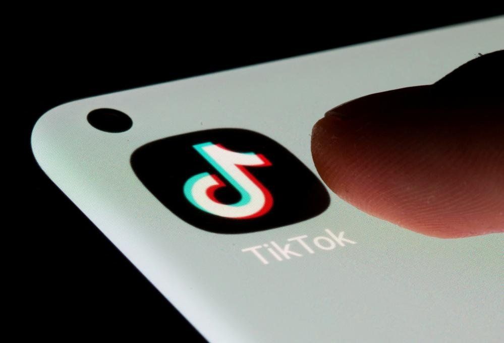 TikTok GV of app on phone with finger clicking it
