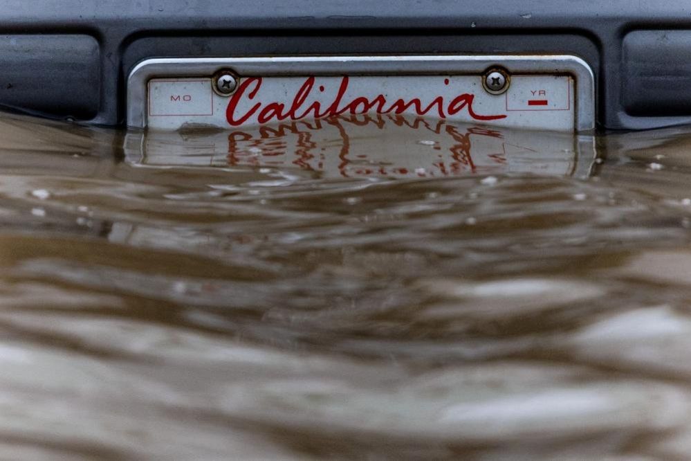 A California number plate is seen at an area affected by floods after days of heavy rain in Pajaro, California, USA