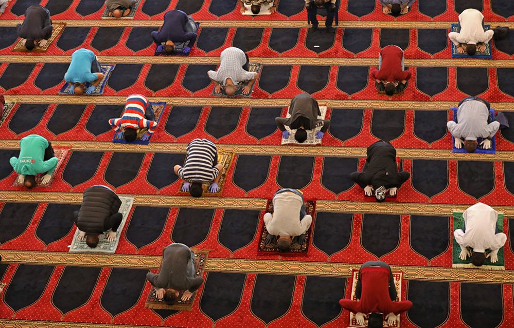 Worshippers pray whilst social distancing