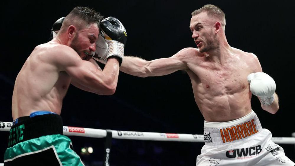 Harry Scarff boxes with the word 'Horrible' across his waist to win the English welterweight title against Louis Greene two years ago