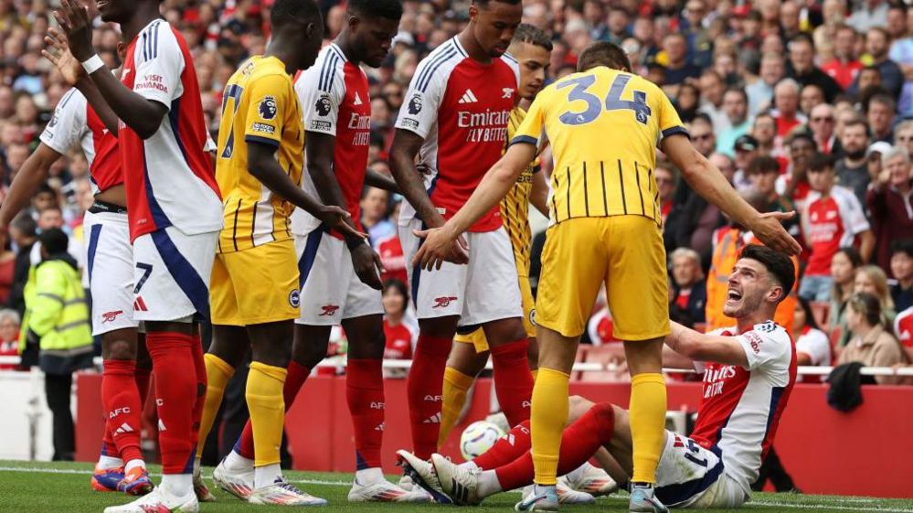 Declan Rice of Arsenal interacts with Joel Veltman of Brighton & Hove Albion before being shown a second yellow card 