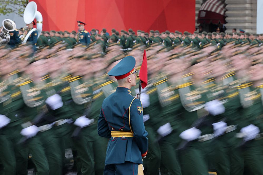 Russian service members march past an honour guard in Red Square in central Moscow, Russia