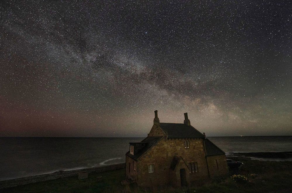 The Bathing House in Howick under a night sky