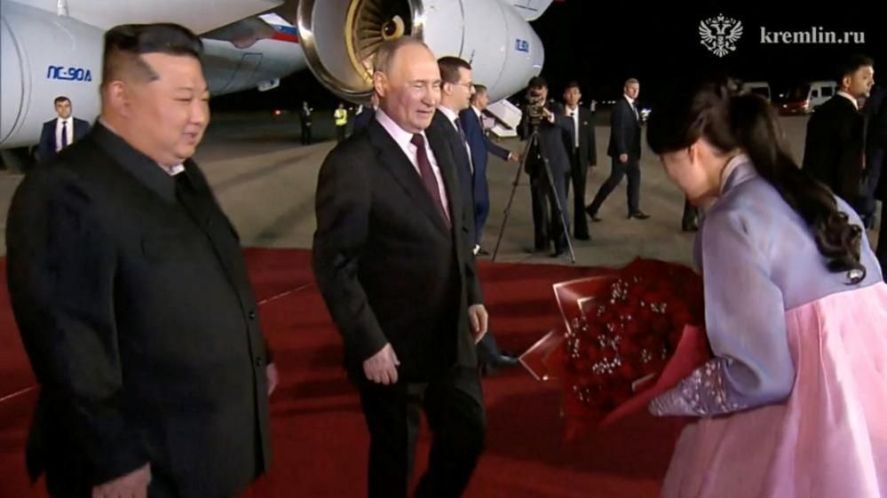 Mr Putin presented with flowers on arrival
