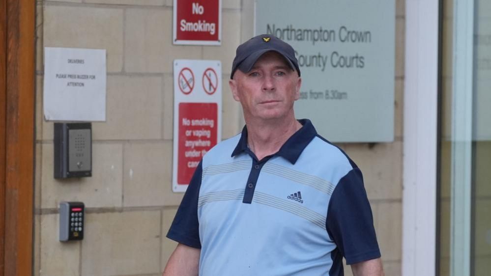 Raymond Connolly outside Northampton Crown Court wearing a blue T-shirt and cap