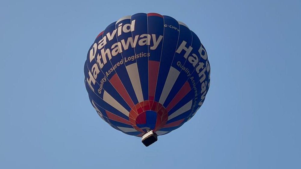 Hot air balloon in flight against blue skies