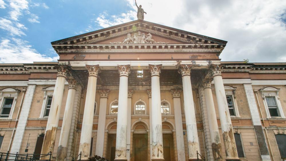 A stock photo shows damage to the front facade of the courthouse