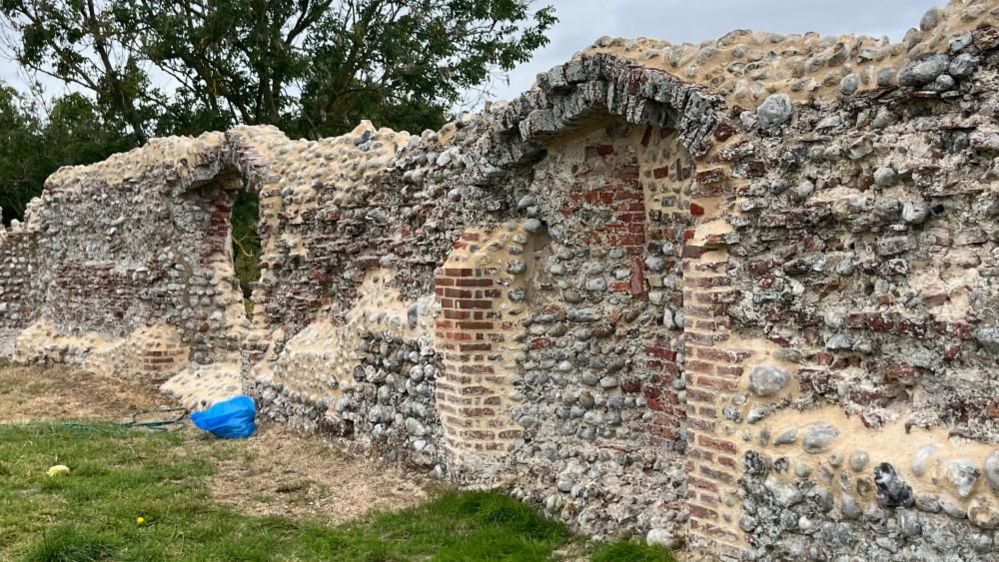 Flint walls with brickwork showing new mortar work to protect the structure from further decay