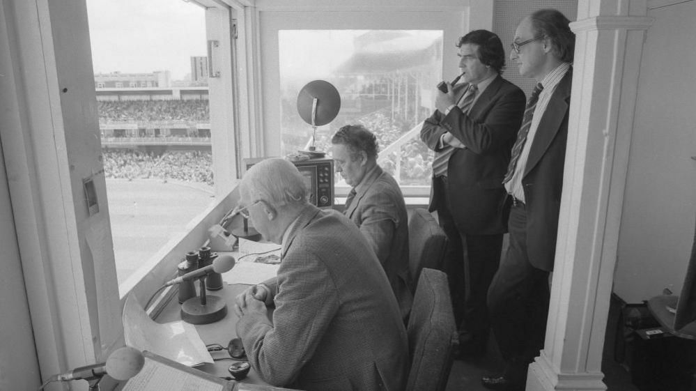 Cricket commentary team in box at match