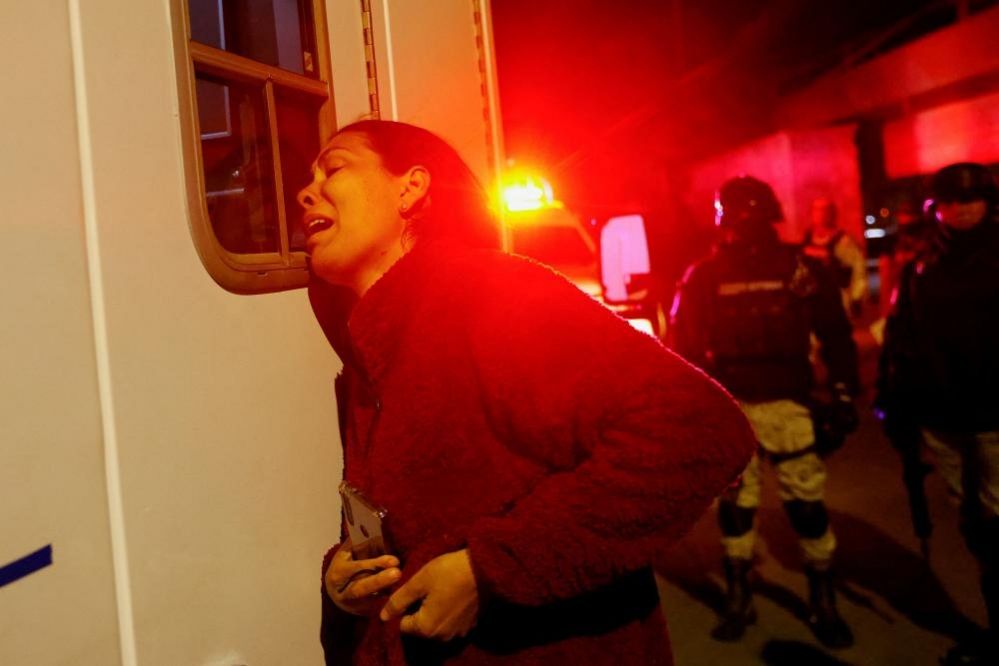 Viangly, a Venezuelan migrant, outside an ambulance that contains her injured husband