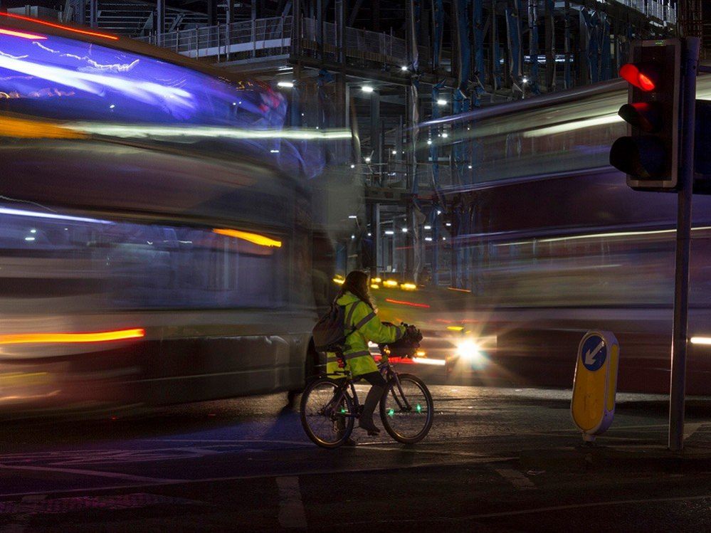 Cyclist in London at night