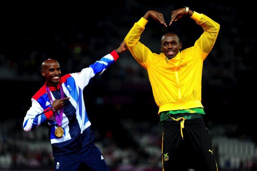 Mo Farah (left) doing Usain Bolt's signature victory pose as Bolt mimics Farah's "Mobot" on day 15 of the London 2012 Olympics