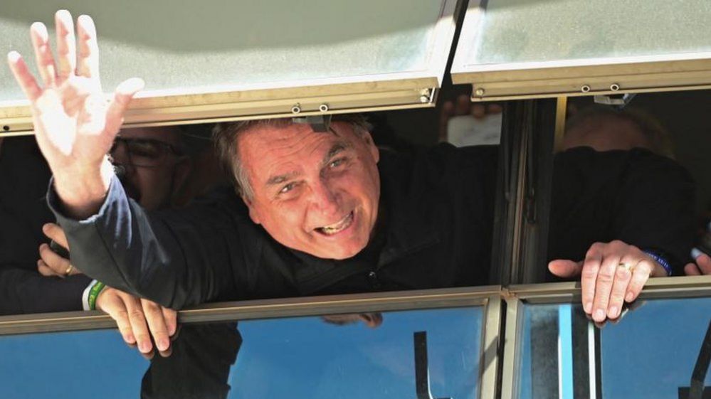 Brazil's former President Jair Bolsonaro waves at Brasilia International Airport as he returns from self imposed exile in Florida, U.S., after the defeat in last year's election, in Brasilia, Brazil March 30, 2023.