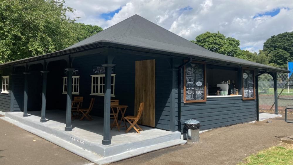 Becket's Park pavilion, a black building housing a cafe