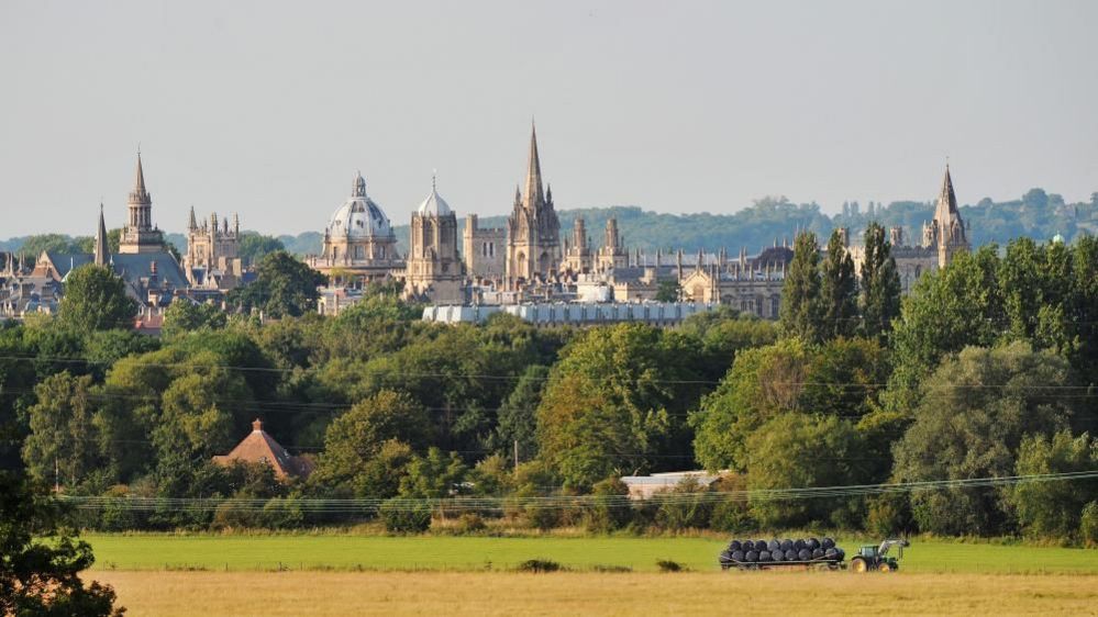 Tractor beneath Oxford skyline