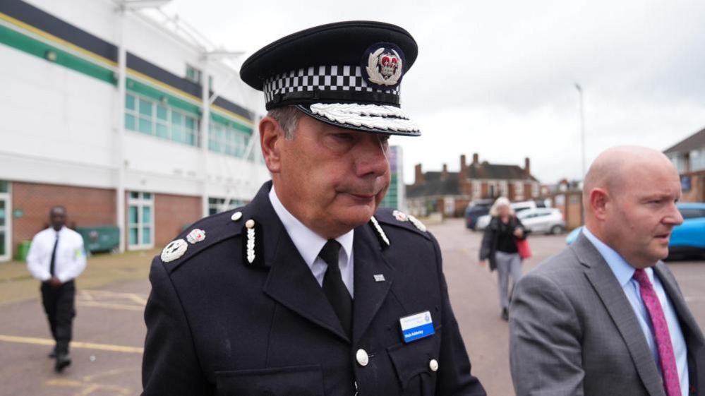 Nick Adderley with short dark hair in a police uniform in the Northampton Saints car park