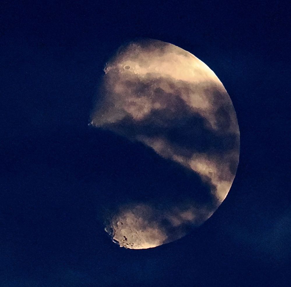 The moon behind clouds