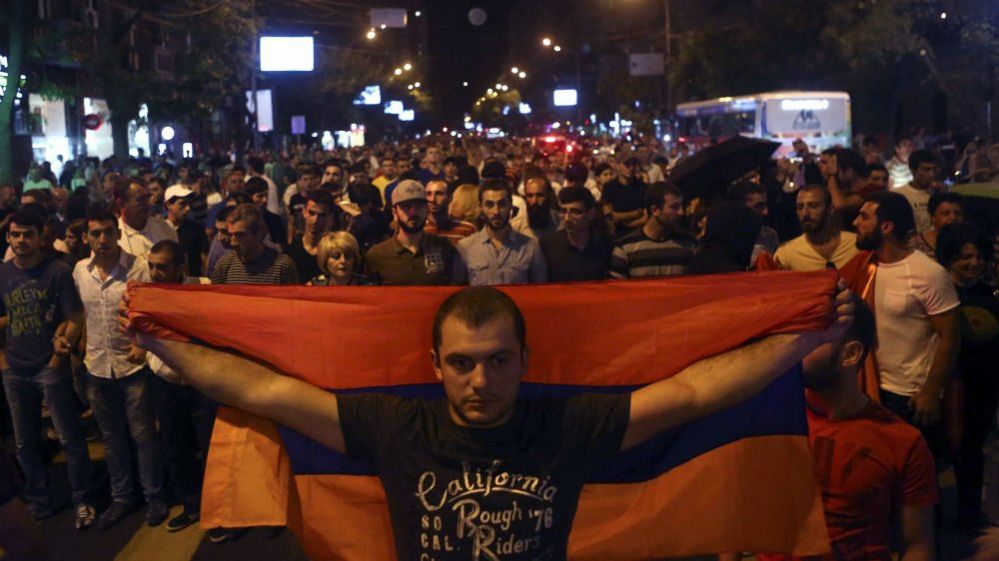 Anti-government protesters, supporters of the armed group who have been holed inside a police station, prepare to march in Yerevan, Armenia, Saturday, July 30, 2016